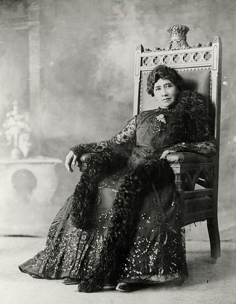 Queen Lili‘uokalani resting on her throne.